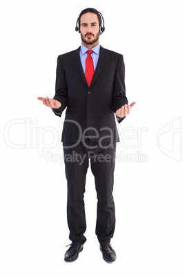 Businessman wearing headphone while holding with hands