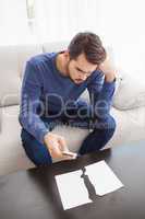 Confused man looking at torn page