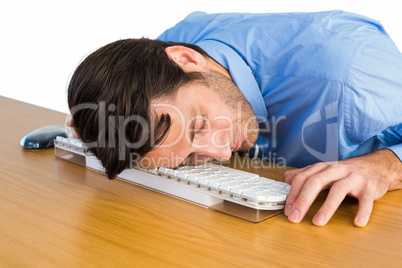 Businessman sleeping with his head on the keyboard