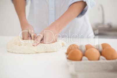 Woman kneading dough on counter