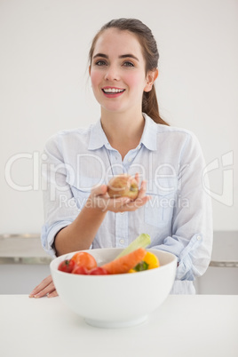 Pretty brunette holding an apple