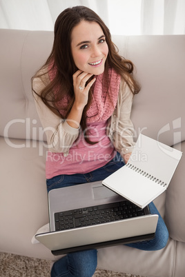 Pretty brunette studying with laptop