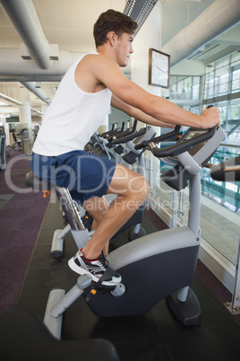 Fit man working out on the exercise bike