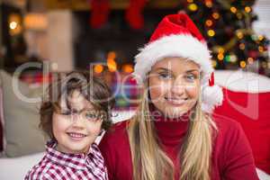 Festive mother and son smiling at camera