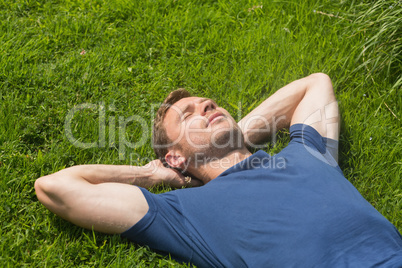 Casual man lying on the grass