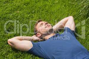 Casual man lying on the grass