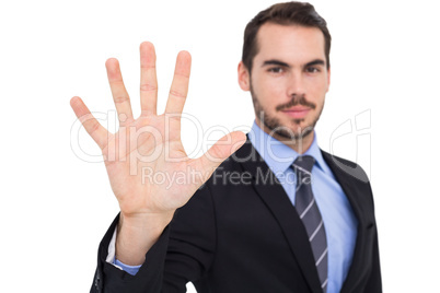 Smiling businessman with fingers spread out