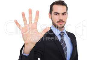 Smiling businessman with fingers spread out
