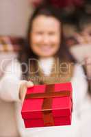 Brunette woman offering christmas gift