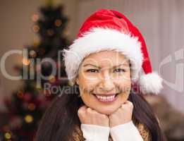 Portrait of a happy brunette in santa hat