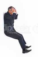 Stressed businessman with head in hands