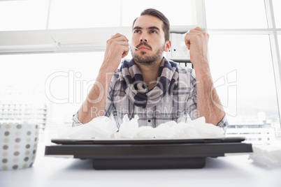 Casual businessman thinking at his desk