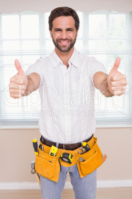 Handyman smiling at camera in tool belt