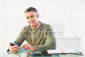 Smiling casual man using tablet pc