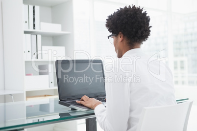 Businessman in shirt using laptop