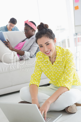 Young creative woman working on floor