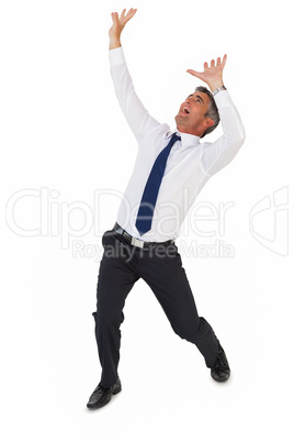 Businessman screaming with arms up