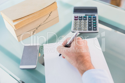 Businessman writing on a paper