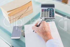 Businessman writing on a paper