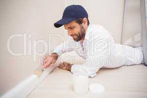 Painter painting the skirting boards