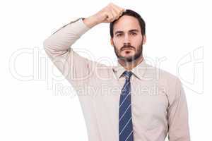 Serious businessman standing with hand on head