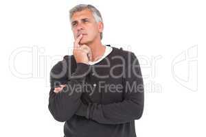 Casual man thinking with hand on chin