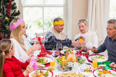 Family in party hat having fun at christmas time
