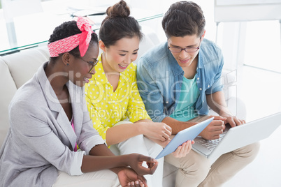 Young creative team working on couch