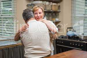 Senior couple hugging and smiling