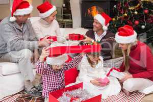 Happy family opening christmas gifts together