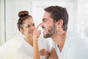 Young woman touching her boyfriends nose