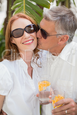 Holidaying couple toasting with cocktails