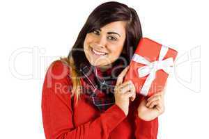Excited brunette holding red gift