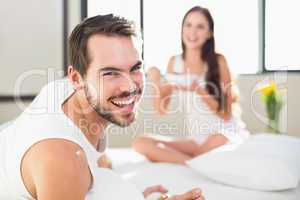 Young couple having breakfast in bed