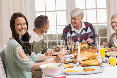 Smiling woman with her family during christmas dinner