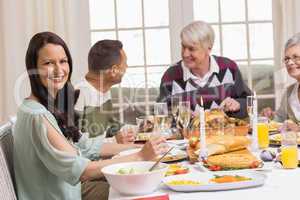 Smiling woman with her family during christmas dinner