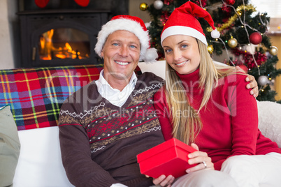 Festive couple holding christmas gifts