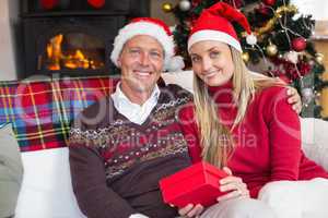 Festive couple holding christmas gifts