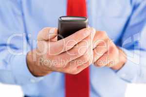 Businessman texting on his mobile phone