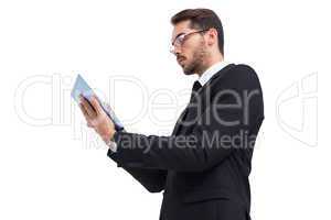 Businessman with glasses using his tablet