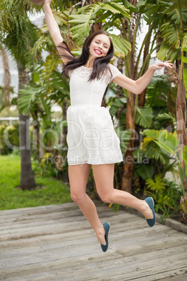 Pretty brunette jumping up and smiling