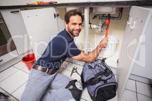 Plumber fixing under the sink