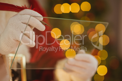 Close up of santa writing list on the glass