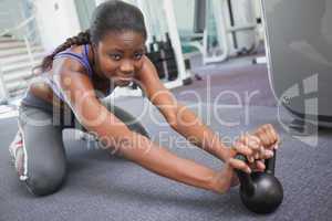 Fit woman working out with kettlebell