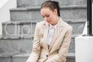 Young businesswoman sitting on steps