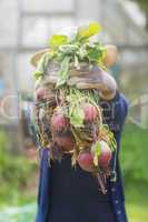 Woman showing home grown vegetables