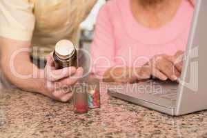 Senior couple looking up medication online