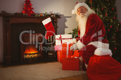 Cheerful santa delivering gifts at christmas eve