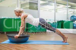 Woman doing fitness exercise in fitness studio