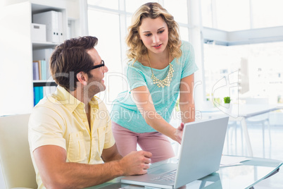 Creative team pointing something on computer screen
